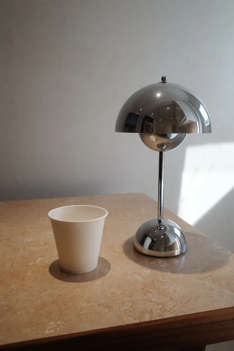 A paper cup beside the chrome lamp on the Lucky cart's stone counter